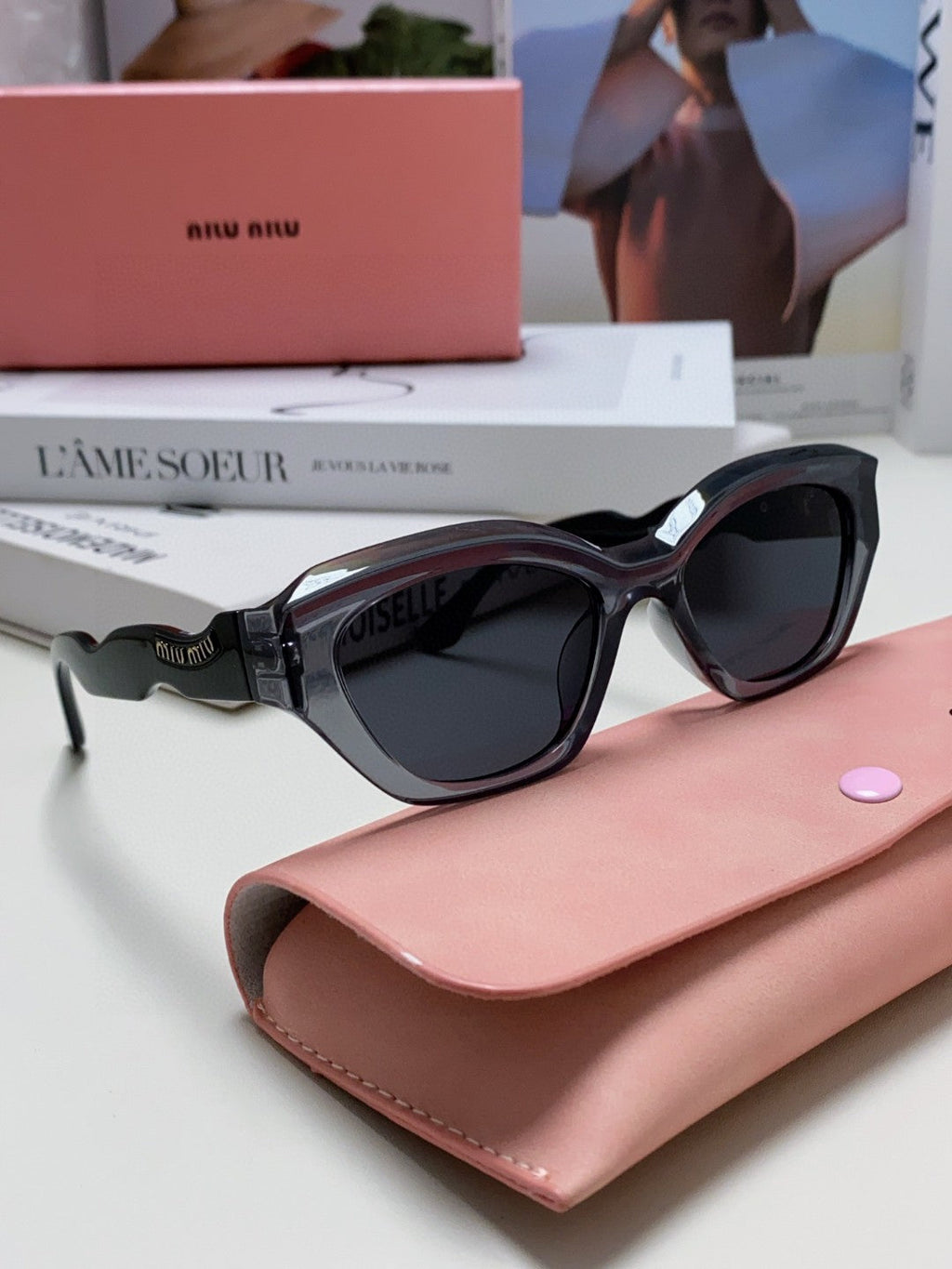 MIU MIU LOGO CAT EYE SUNGLASSES 513006 IN BLACK AND GREY CLEAR ACETATE WAVY FRAME